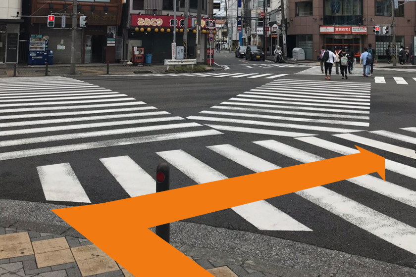 しばらく進むと大きな交差点に出ます。その交差点を右折し、信号を渡ってください